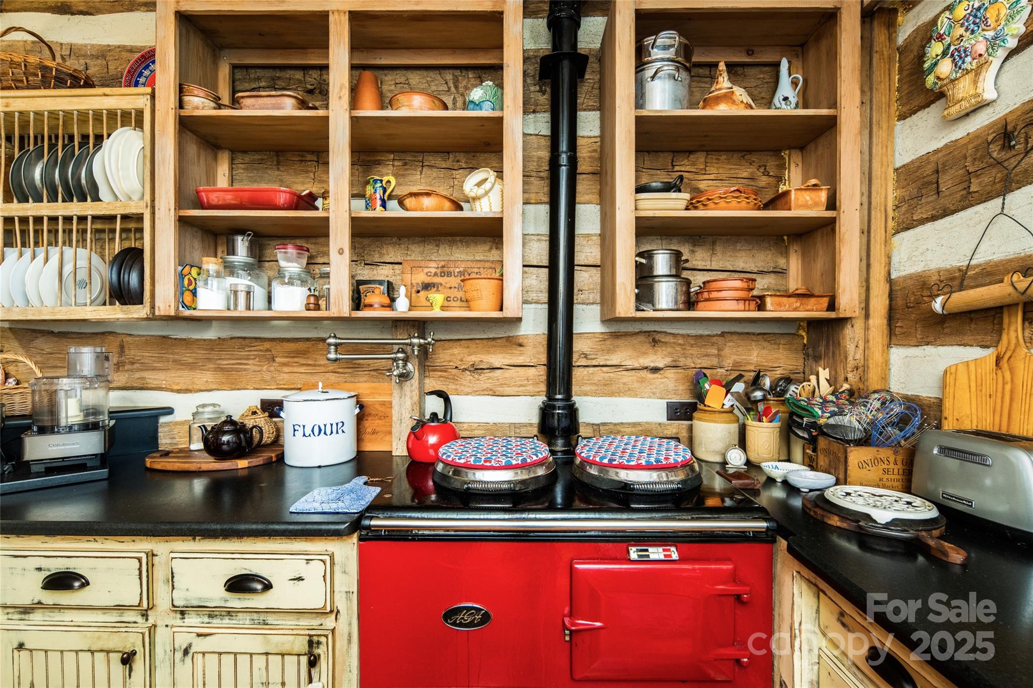 69 Dogwood Branch Road Zirconia, NC 28790 - Photo 21 of 48 a kitchen with lots of clutter and cabinets