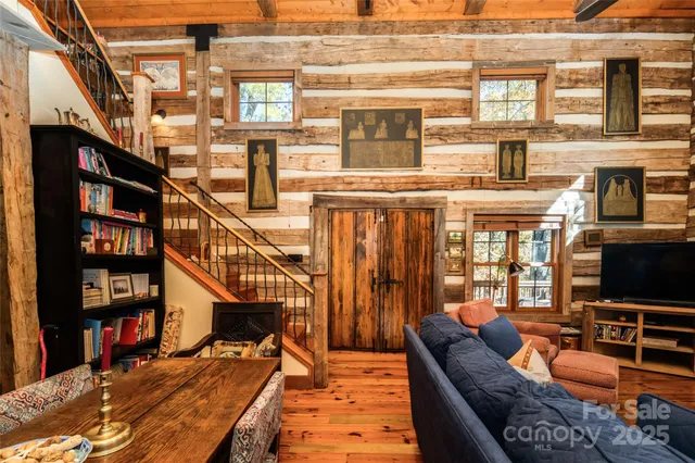 a bedroom with a bed bookshelf and a large window