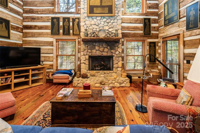 a bedroom with a bed and dresser with wooden floor