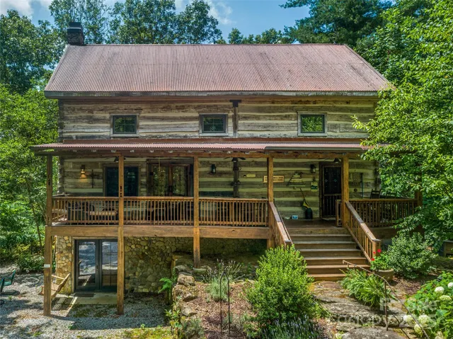 a front view of a house with plants