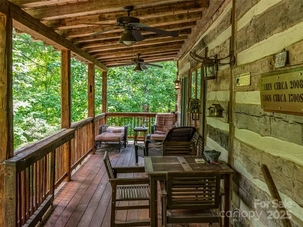 a patio with wooden floor a yard a table and chairs