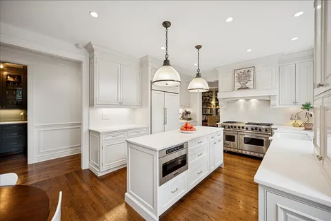 a kitchen with stove and cabinets