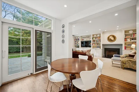 a living room with furniture a fireplace and a floor to ceiling window