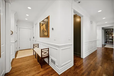 a view of a hallway with wooden floor windows and livingroom