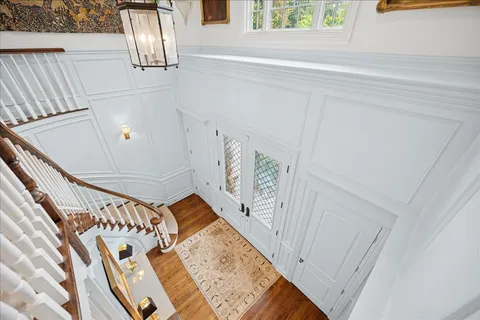 a bedroom with a bed a fireplace and a flat tv screen