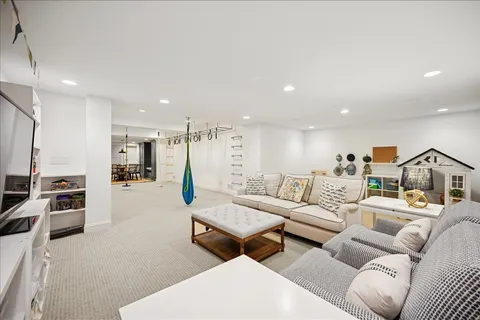 a kitchen with stainless steel appliances a dining table chairs and white cabinets