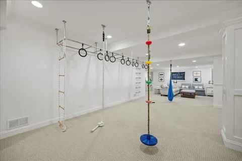 a spacious bedroom with a bed and a lamp