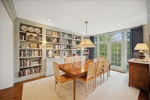 a dining room with furniture and a book shelf