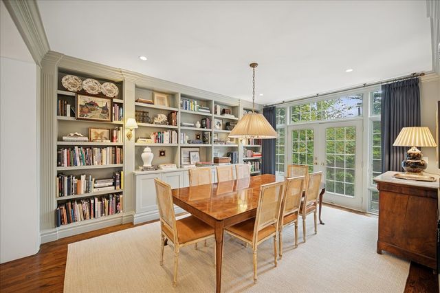a dining room with furniture and a book shelf