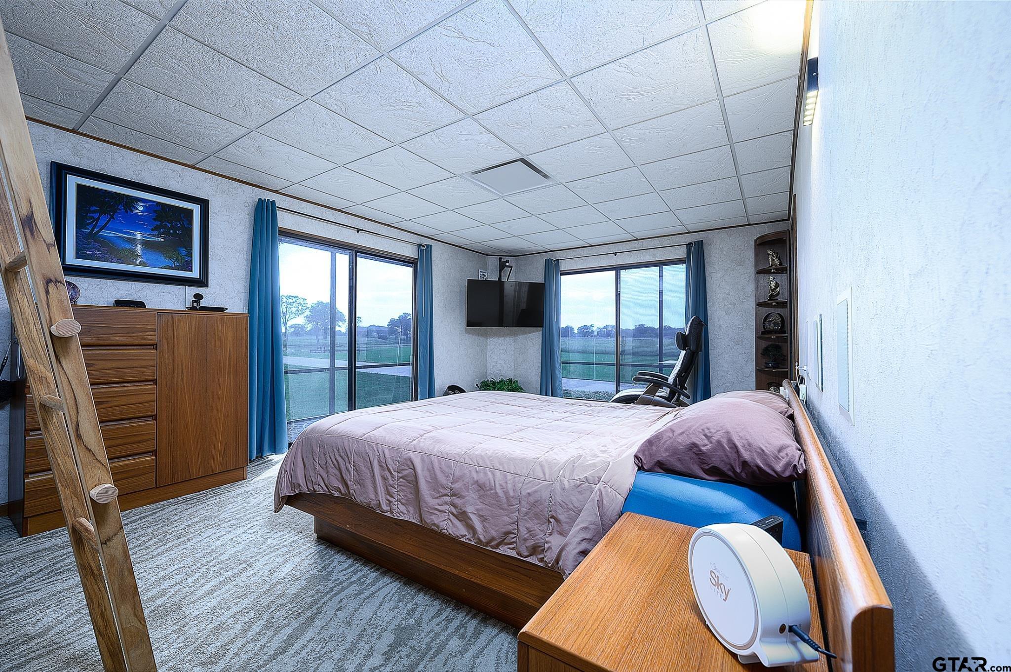 1085 County Road 1960 Yantis, TX 75497 - Photo 27 of 41 a bedroom with a bed and a dresser next to a window