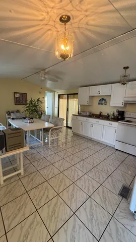 a large kitchen with lots of counter top space appliances and cabinets