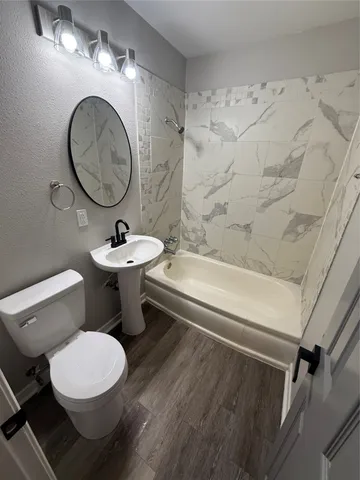 a bathroom with a sink a toilet and a mirror