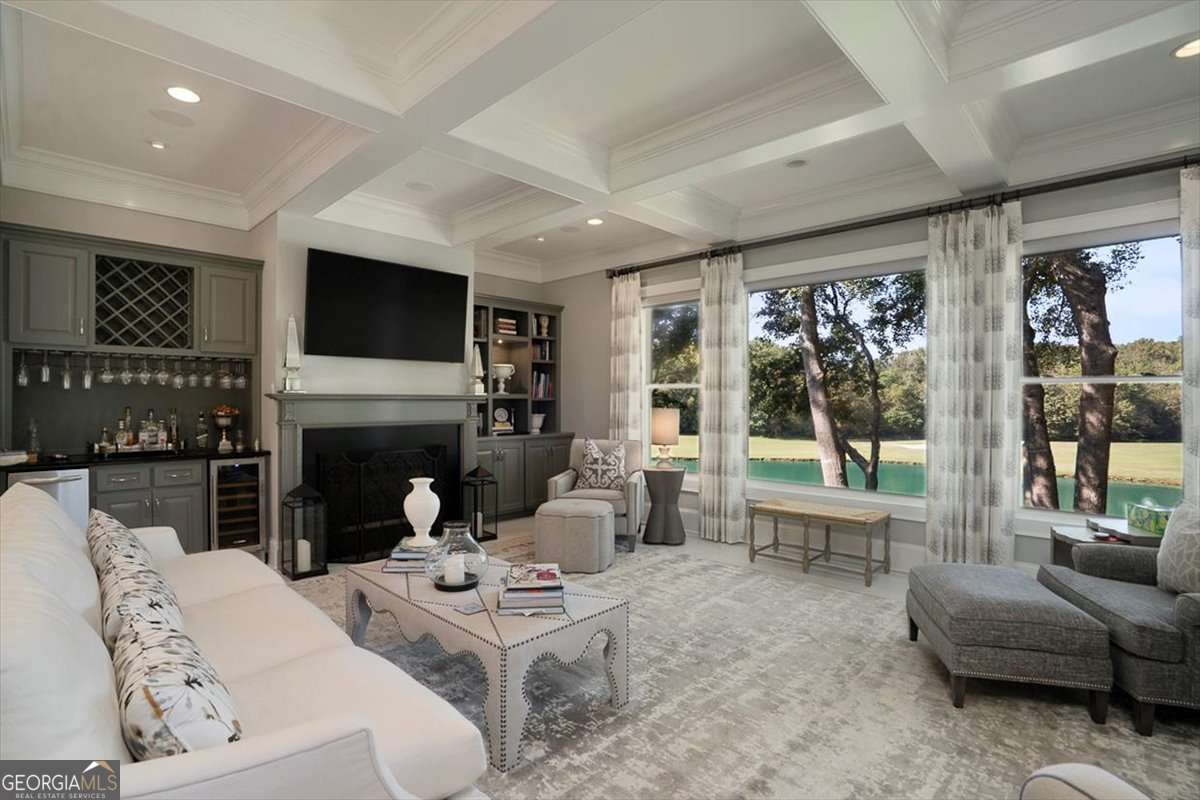 711 Bluff Road Statham, GA 30666 - Photo 18 of 70 a living room with furniture a fireplace a flat screen tv and floor to ceiling window