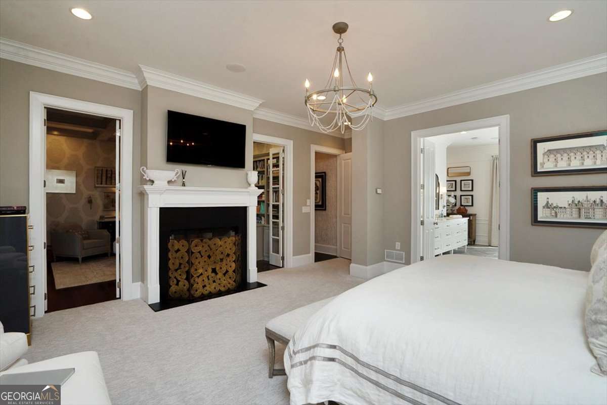 711 Bluff Road Statham, GA 30666 - Photo 35 of 70 a spacious bedroom with a bed and a fireplace