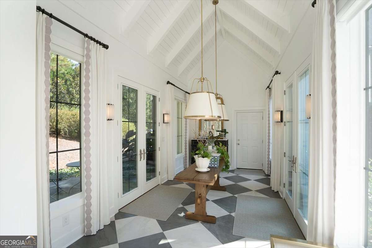 711 Bluff Road Statham, GA 30666 - Photo 39 of 79 a living room with furniture and a floor to ceiling window