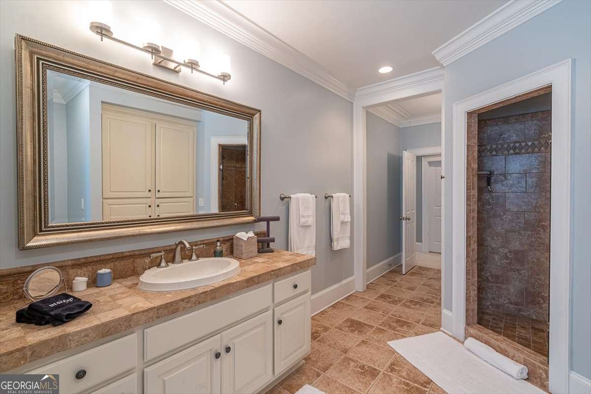 711 Bluff Road Statham, GA 30666 - Photo 43 of 70 a bathroom with a double vanity sink and a mirror