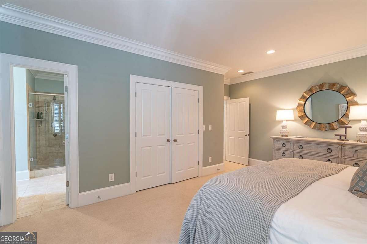 711 Bluff Road Statham, GA 30666 - Photo 45 of 70 a bedroom with a bed and a mirror