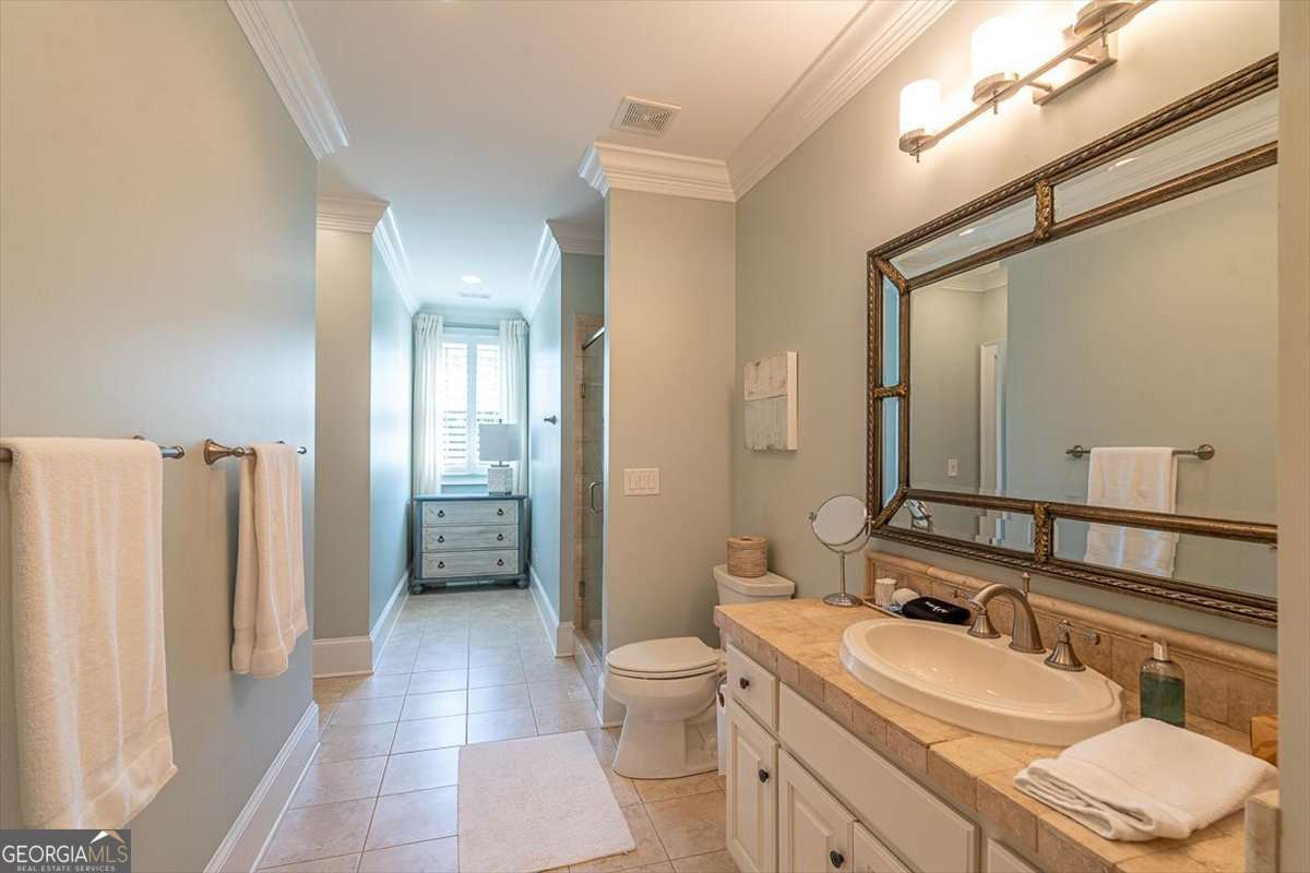 711 Bluff Road Statham, GA 30666 - Photo 48 of 79 a bathroom with a toilet a sink and a mirror