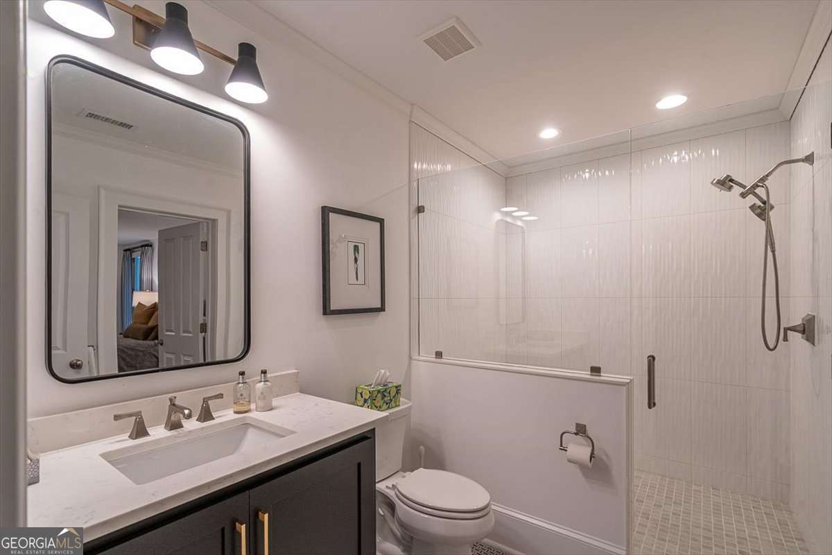 711 Bluff Road Statham, GA 30666 - Photo 53 of 70 a bathroom with a sink a toilet a mirror and shower