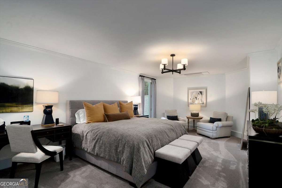 711 Bluff Road Statham, GA 30666 - Photo 56 of 79 a spacious bedroom with a bed a couch and a flat screen tv