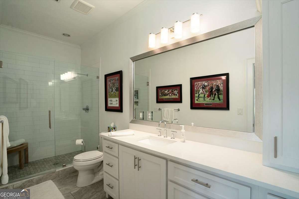 711 Bluff Road Statham, GA 30666 - Photo 60 of 79 a bathroom with a toilet sink and mirror