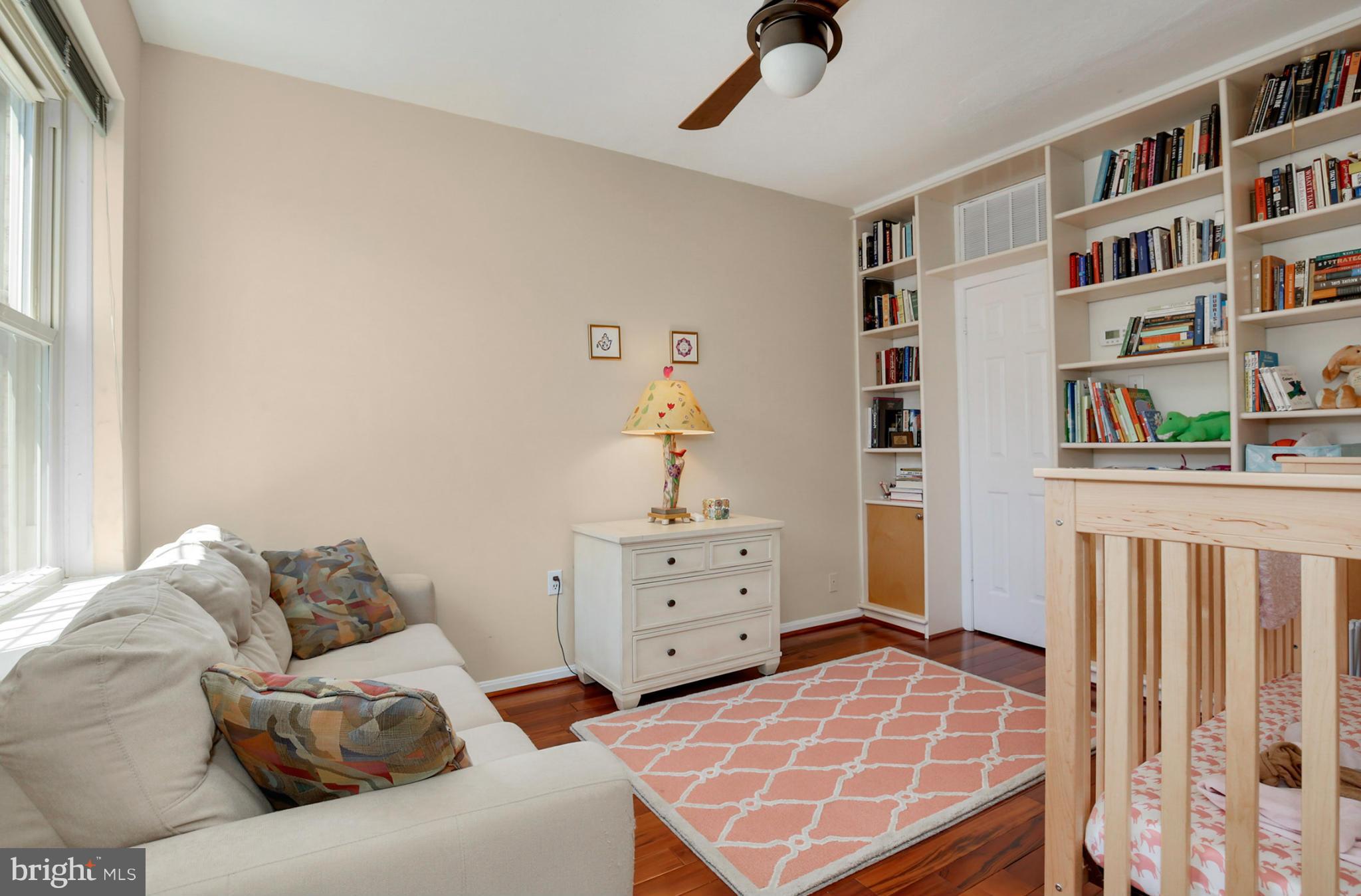 1454 Euclid Street Northwest, Unit 7 Washington, DC 20009 - Photo 20 of 23 a bedroom with a bed and a book shelf