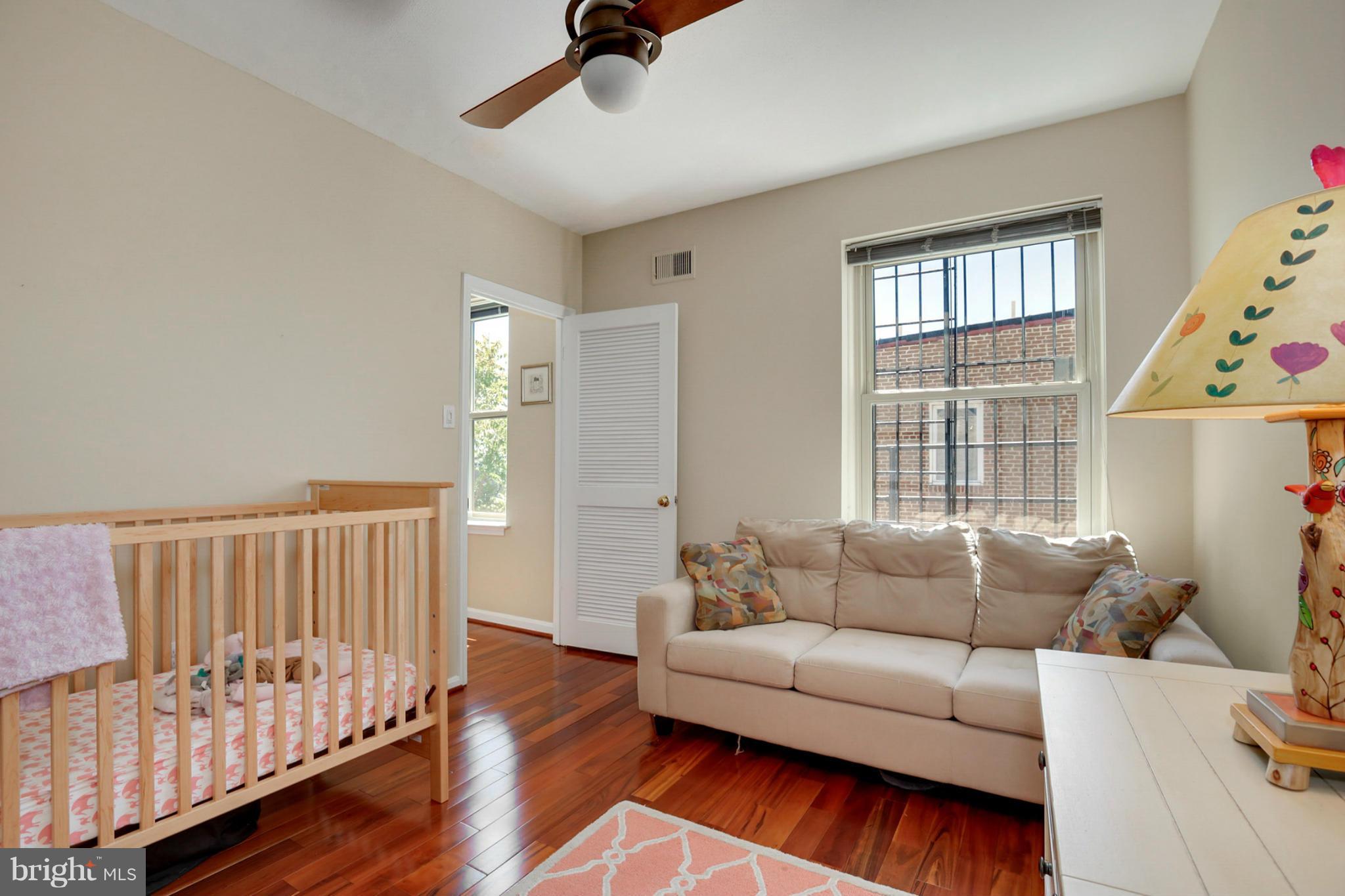 1454 Euclid Street Northwest, Unit 7 Washington, DC 20009 - Photo 21 of 23 a living room with furniture and wooden floor