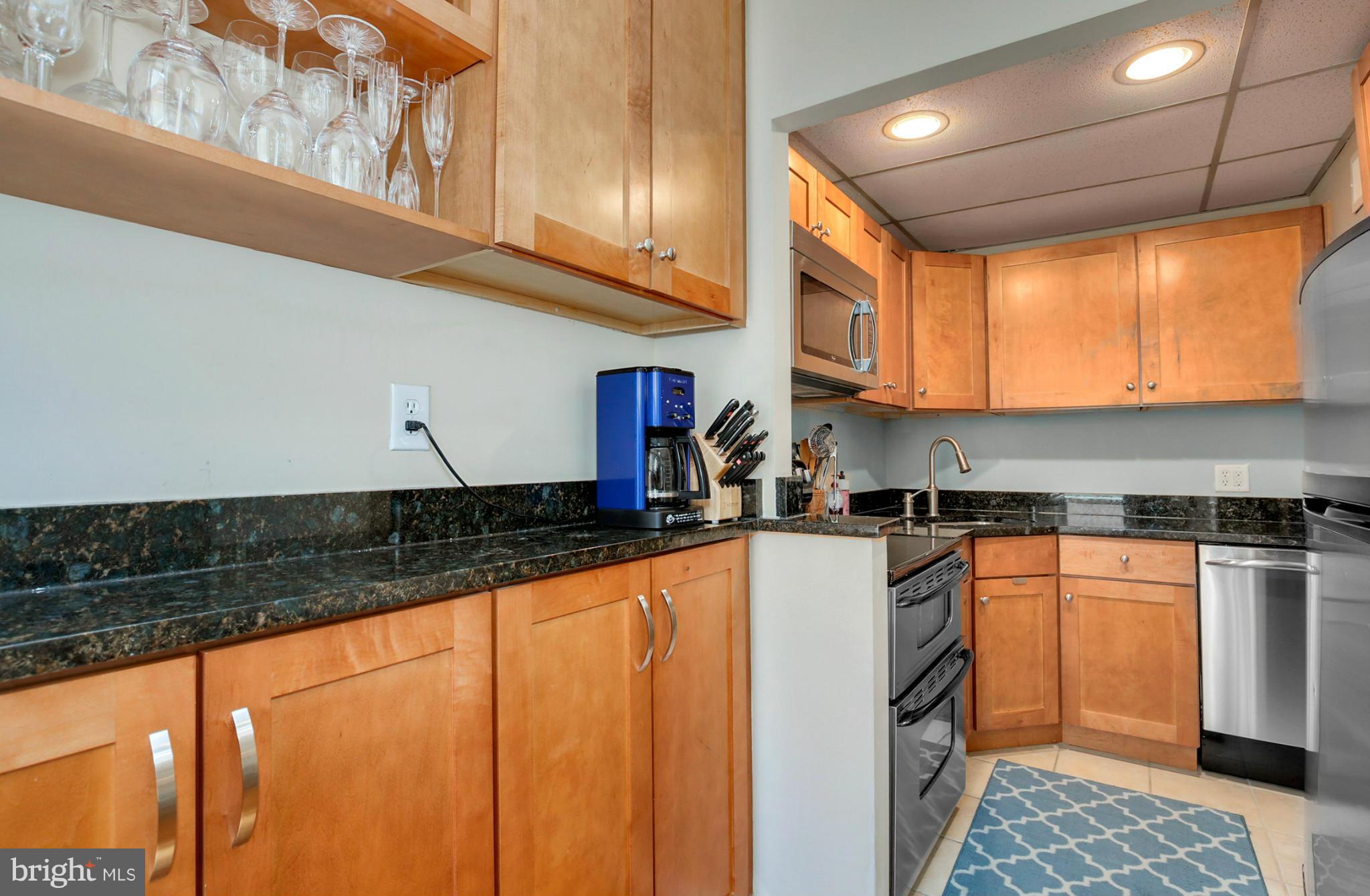 1454 Euclid Street Northwest, Unit 7 Washington, DC 20009 - Photo 8 of 23 a kitchen with stainless steel appliances granite countertop a sink and a refrigerator