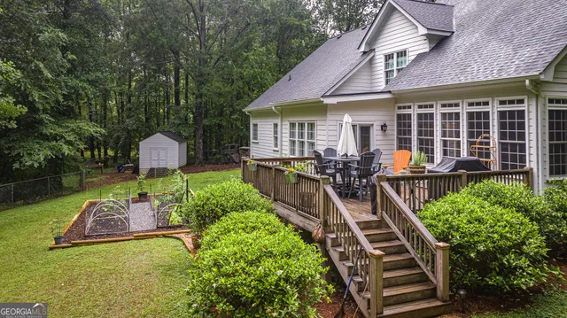 a view of a house with backyard water fountain and sitting area