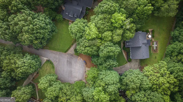 an aerial view of a house with a yard and outdoor seating