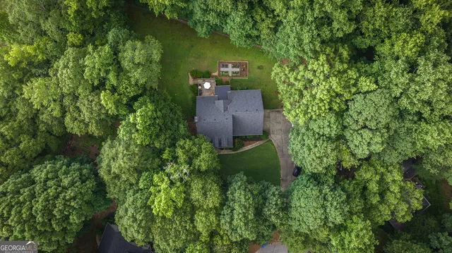 an aerial view of a house with a yard