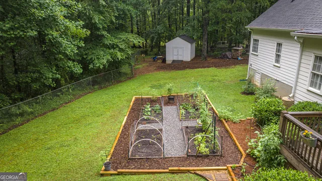 a backyard of a house with barbeque oven table and chairs