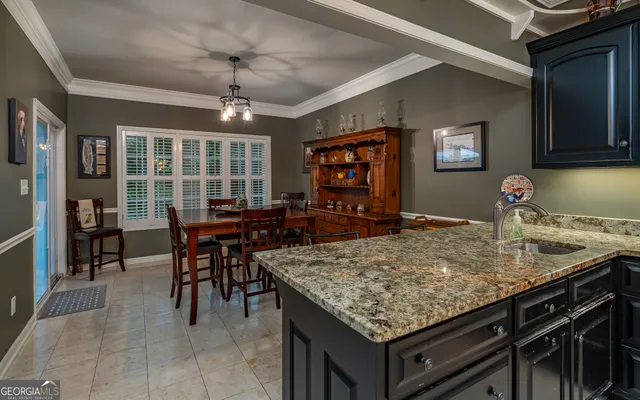 a kitchen with a table chairs and cabinets