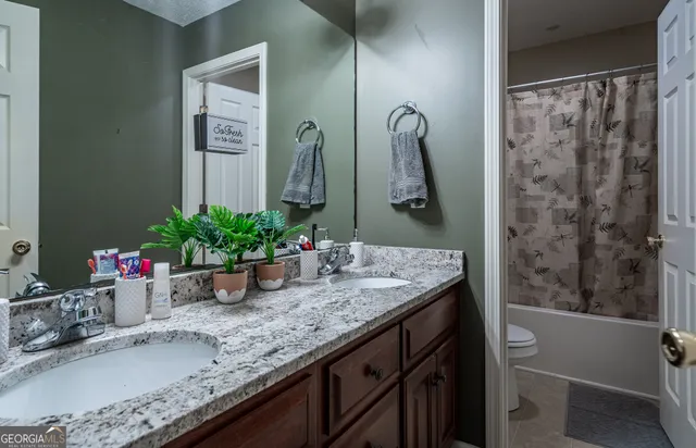 a spacious bedroom with a bed and a chandelier
