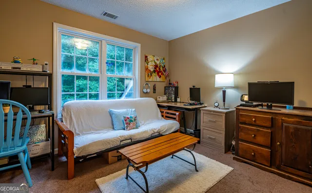 a spacious bedroom with a bed and a chandelier