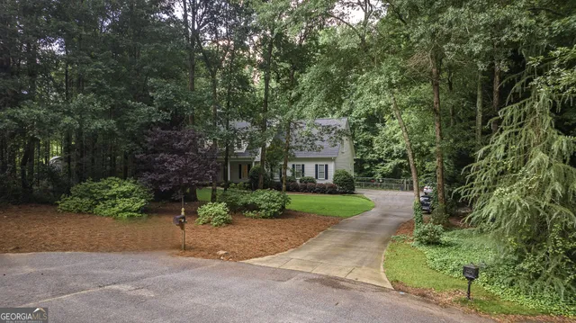 a view of a house with a yard and tree s