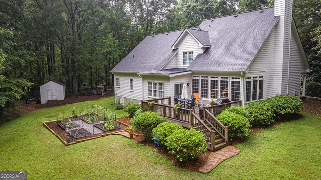 an aerial view of a house having patio with a garden