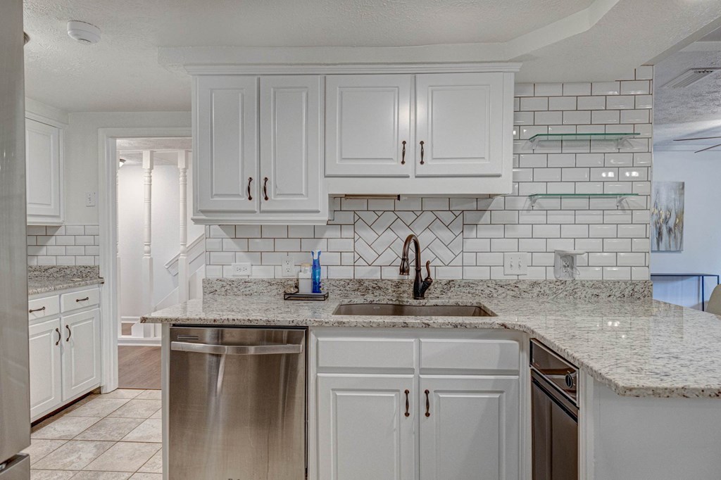 6101 River Road, Unit 5 Columbus, GA 31904 - Photo 15 of 47 a kitchen with stainless steel appliances granite countertop a sink stove and cabinets