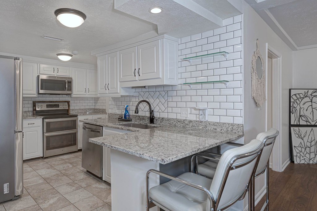 6101 River Road, Unit 5 Columbus, GA 31904 - Photo 16 of 47 a kitchen with stainless steel appliances granite countertop a sink stove and refrigerator