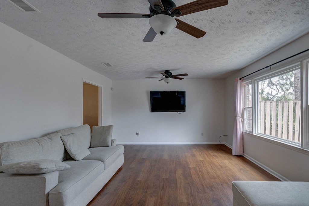 6101 River Road, Unit 5 Columbus, GA 31904 - Photo 20 of 47 a living room with furniture and a flat screen tv