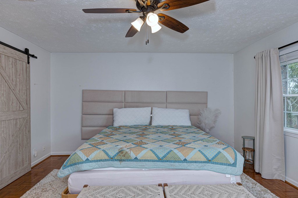 6101 River Road, Unit 5 Columbus, GA 31904 - Photo 27 of 47 a bedroom with a bed and a ceiling fan