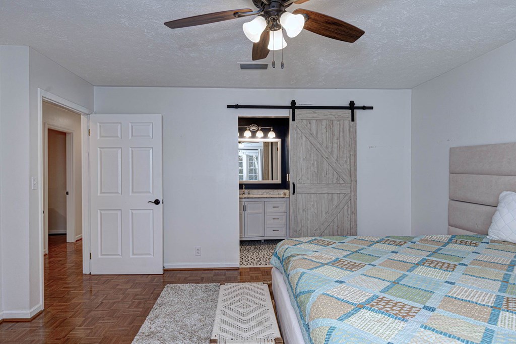 6101 River Road, Unit 5 Columbus, GA 31904 - Photo 28 of 47 a bedroom with a bed and a chandelier