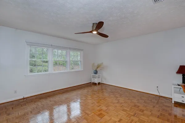 a view of a livingroom with a ceiling fan and window