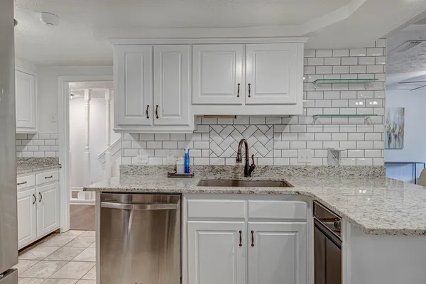a kitchen with stainless steel appliances granite countertop a sink stove and cabinets