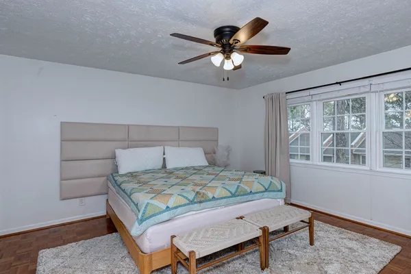 a bedroom with a bed a table and chair