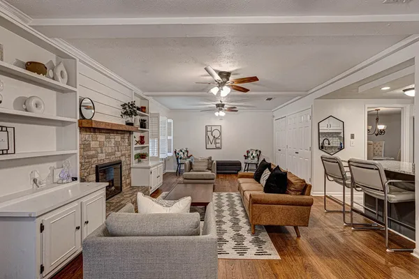 a living room with furniture a fireplace and a flat screen tv