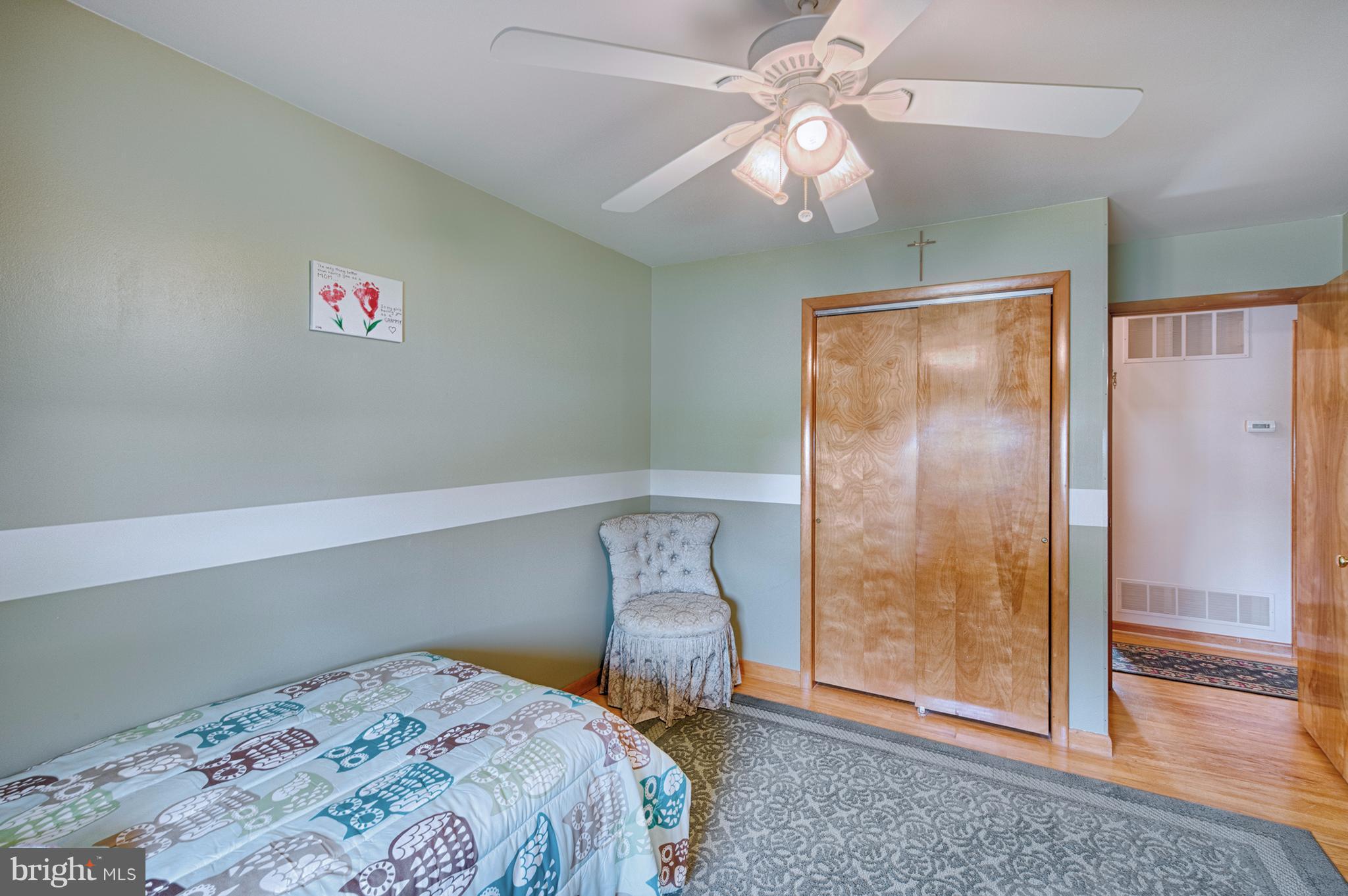 9501 Dawnvale Road Baltimore, MD 21236 - Photo 18 of 30 a bedroom with a bed and a chandelier