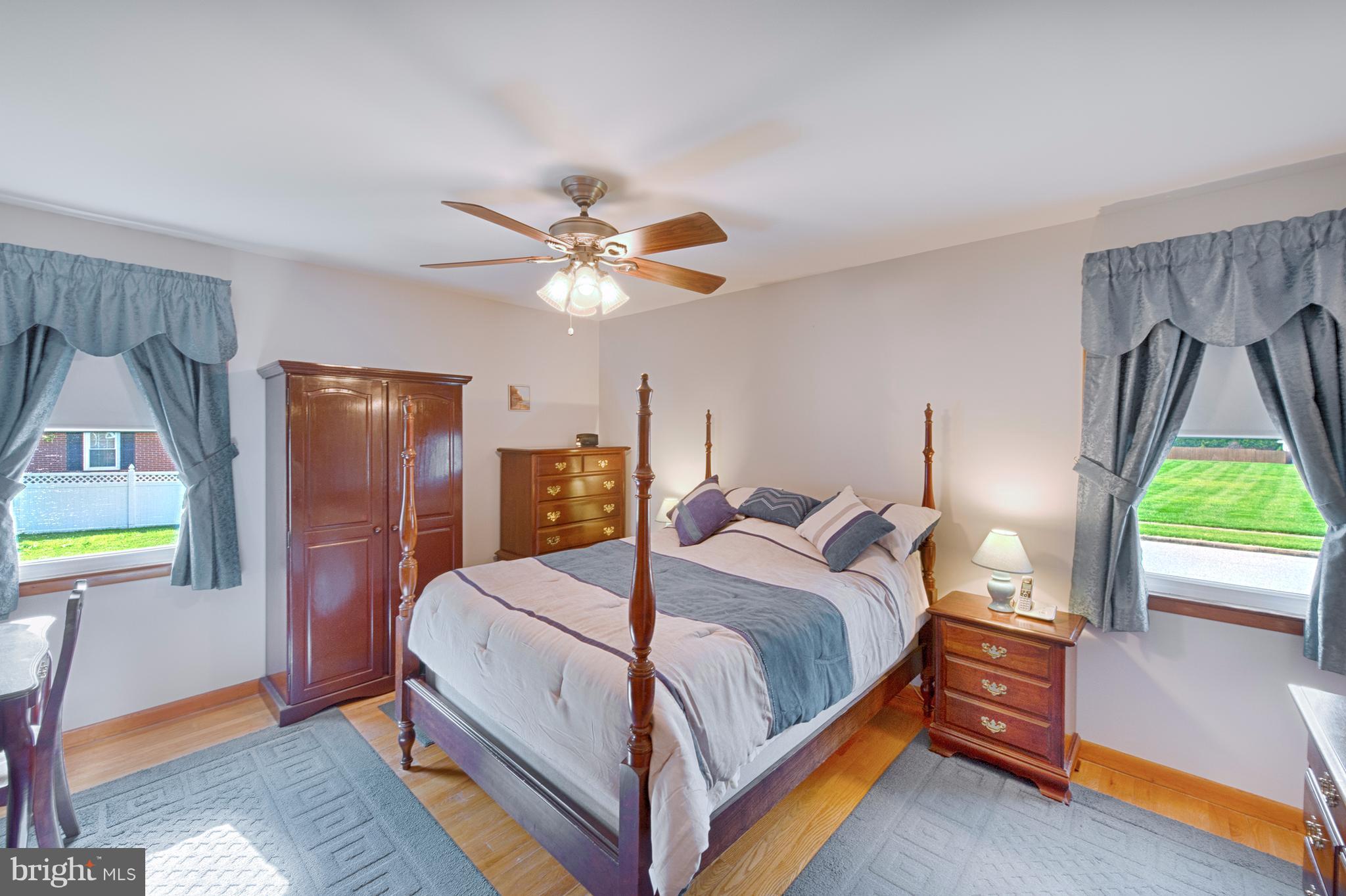 9501 Dawnvale Road Baltimore, MD 21236 - Photo 19 of 30 a bedroom with a bed a window and a chandelier