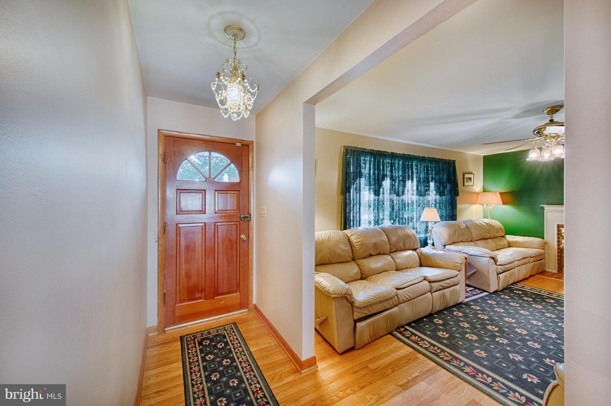 9501 Dawnvale Road Baltimore, MD 21236 - Photo 4 of 30 a living room with furniture and a chandelier