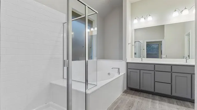 a spacious bathroom with a tub shower and sink
